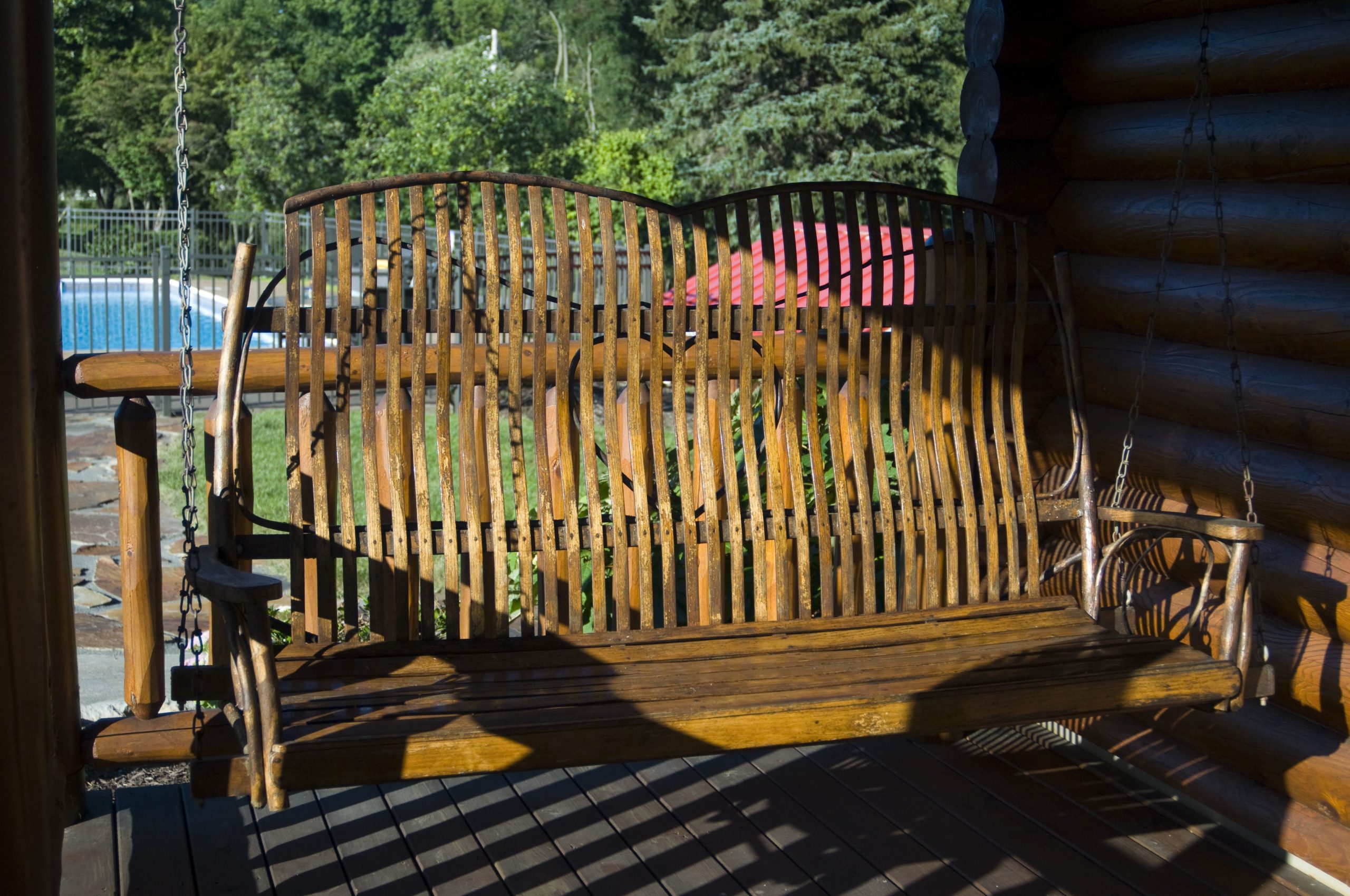Swing bench on log cabin porch at Silvermist