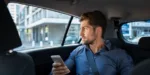 man-holding-phone-riding-in-car Silvermist young adult drug and alcohol rehab