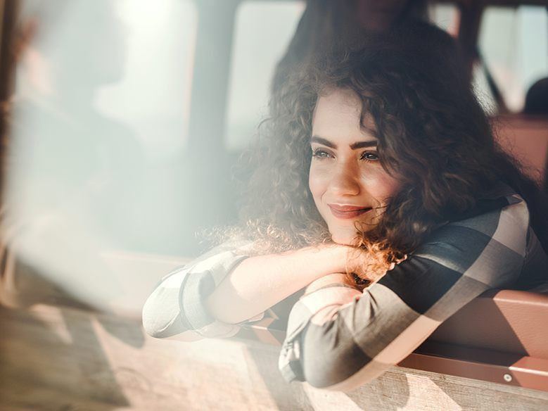 Young adult caucasian woman looking out a window