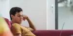 young-adult-sitting-on-couch-bored-on-phone Silvermist young adult drug and alcohol rehab