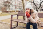 Depression. Sad woman in trouble sitting on bench in fall park alone thinking. Feeling lonely and upset. Mental health