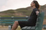 a-happy-good-looking-man-smiling-sitting-on-a-park-bench-stockpack-istock
