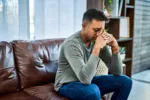 shot-of-a-man-looking-stressed-while-sitting-on-the-sofa-at-home-stockpack-gettyimages