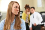 businesswoman-being-gossiped-about-by-colleagues-in-office-stockpack-gettyimages-scaled-jpg