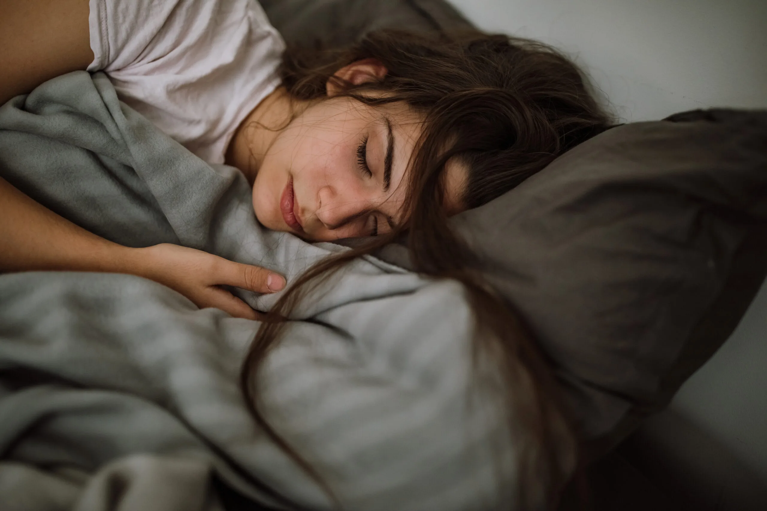 young-woman-sleeping-in-bedroom-stockpack-gettyimages-scaled-jpg (1)