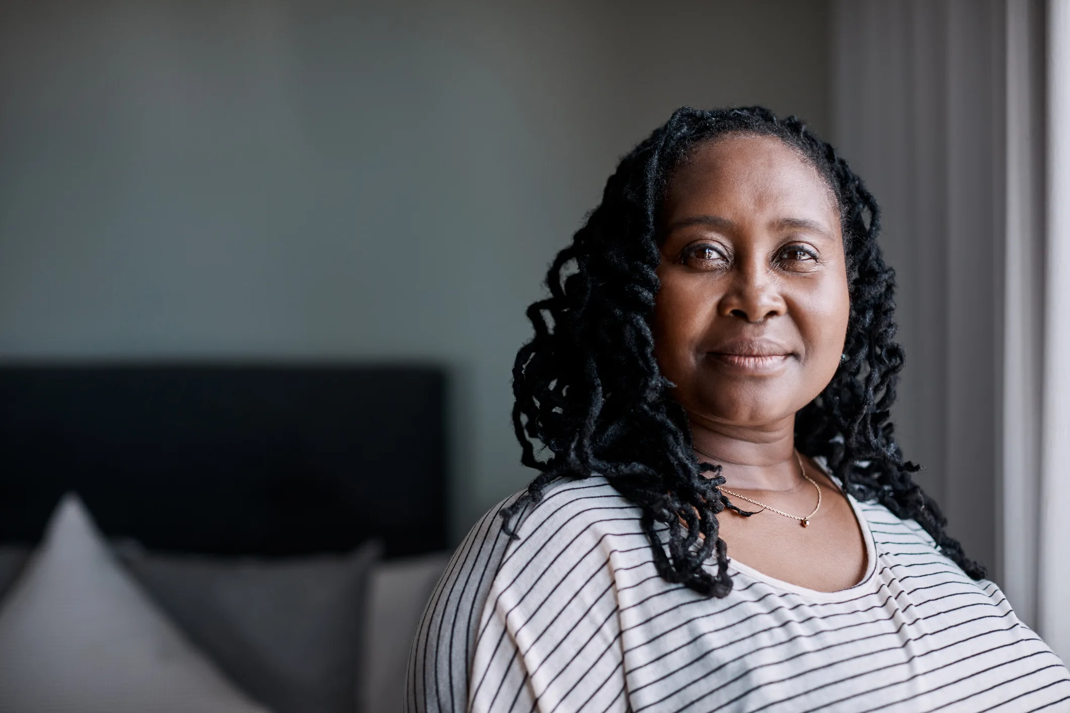 Adult woman smiling in her home, a teetotaler