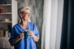 A woman smiling as she finds happiness in solitude after recovery