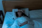 Young woman waking up after a night of drinking