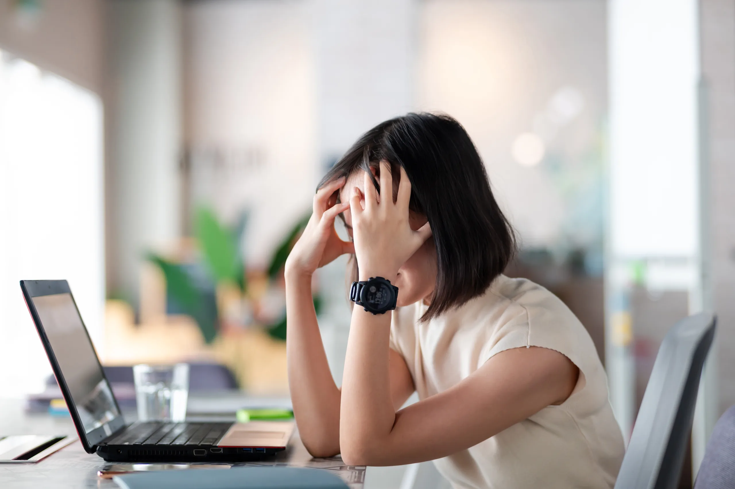 Asian woman feel exhausted and stress after long hour working in the office.