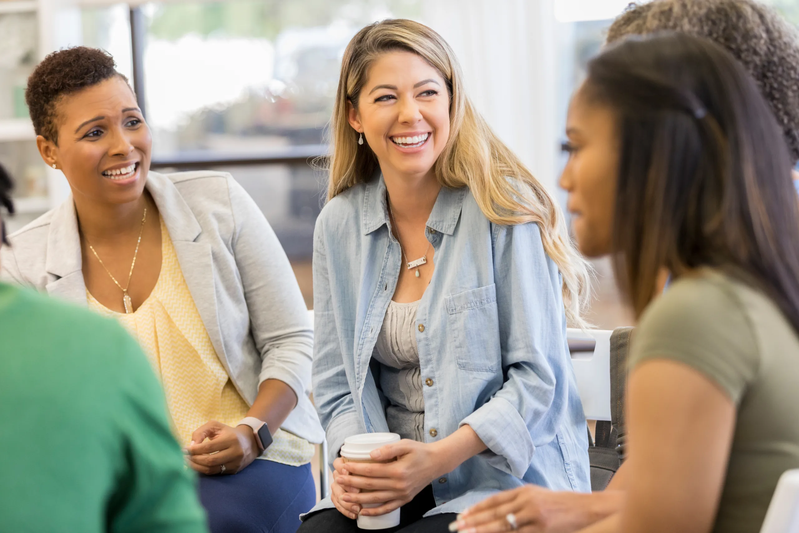 Mid adult woman talks about something during a support group or group therapy meeting at Silvermist Recovery in PA