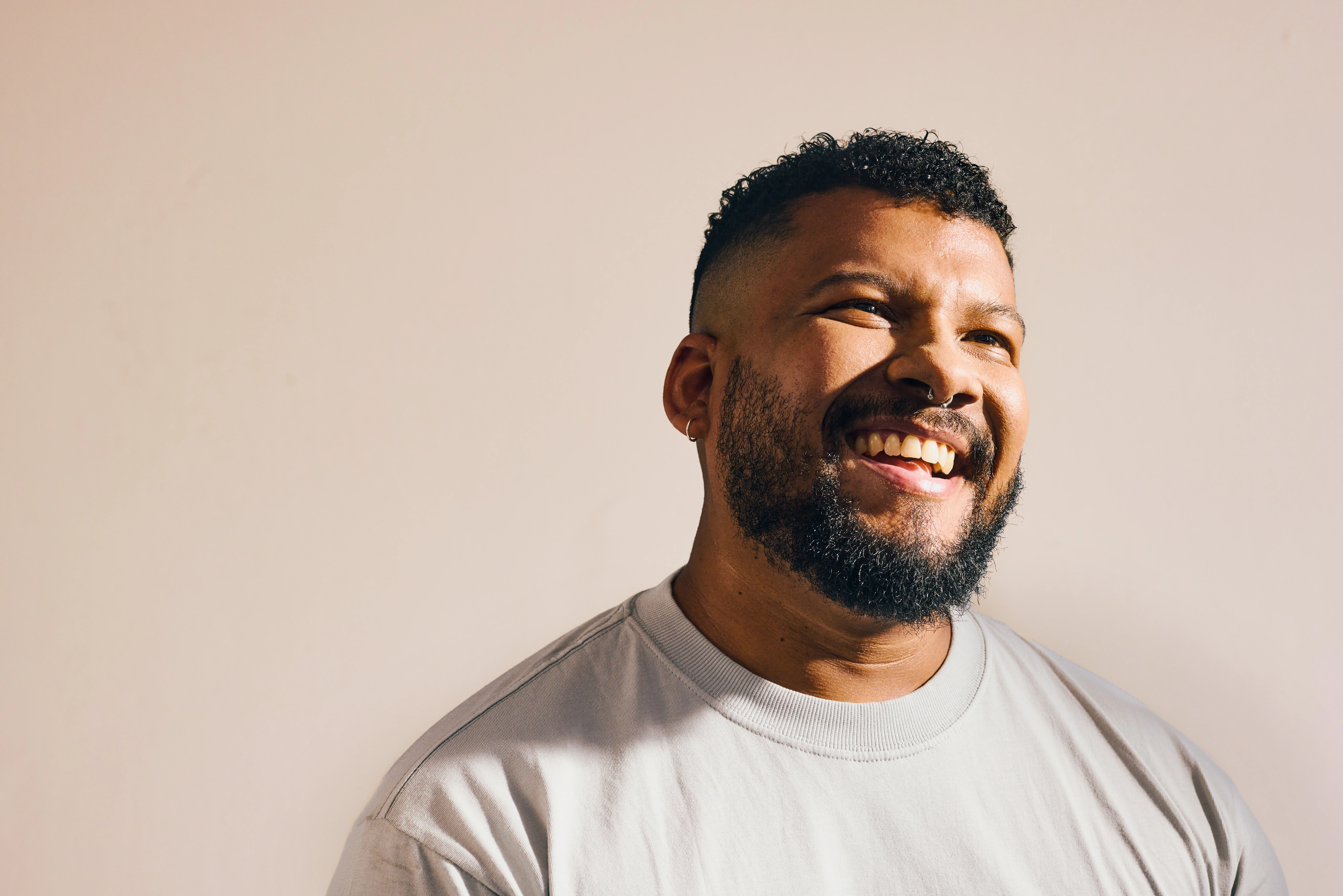 Male wearing t-shirt and looking up laughing. Beauty and wellness concept.