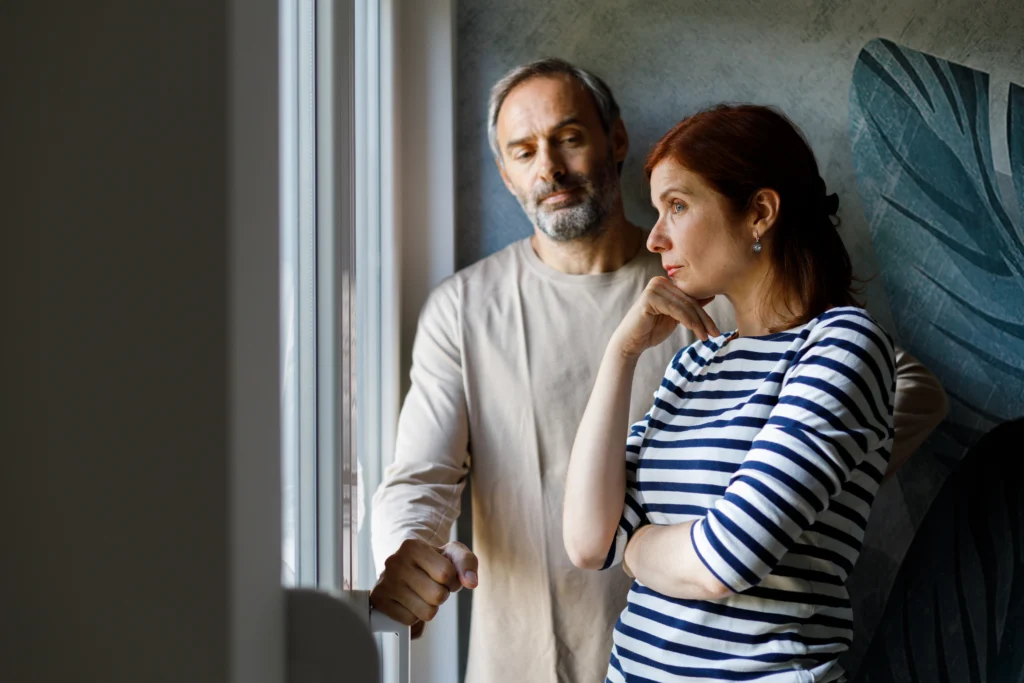 Mature couple fighting at home sitting on the sofa.